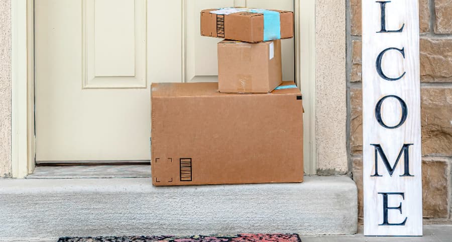 Packages on the doorstep of a home with a welcome sign in Cleveland